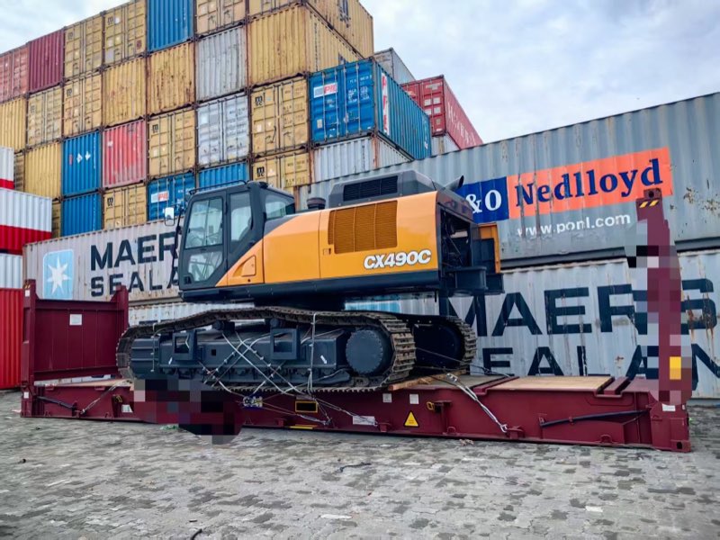 At the port among stacked containers.