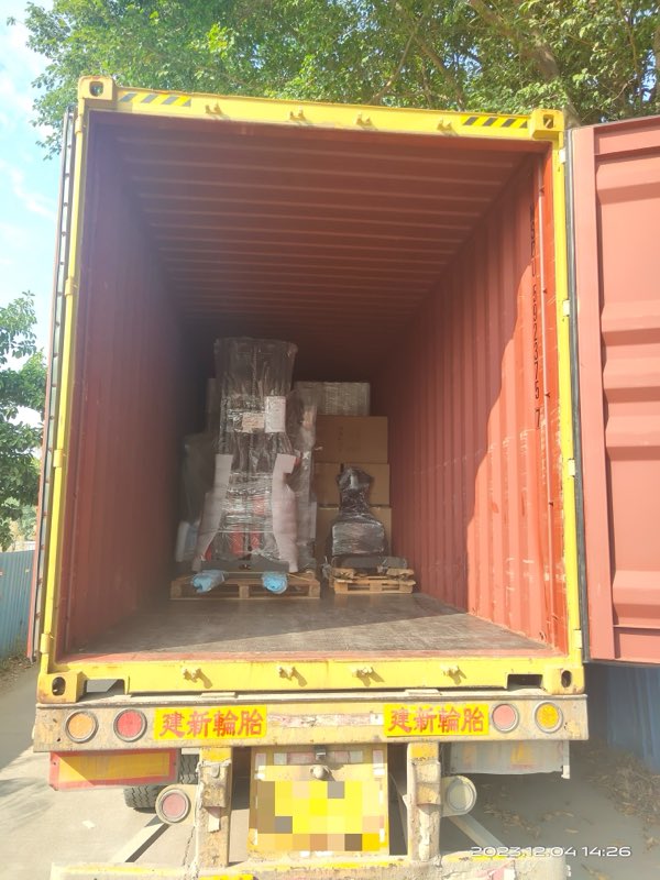 Stackers and pallet jacks, wrapped and loaded in a container.