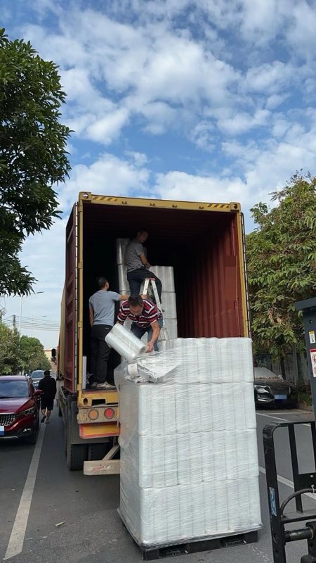 Loading the stretch film rolls into the container.
