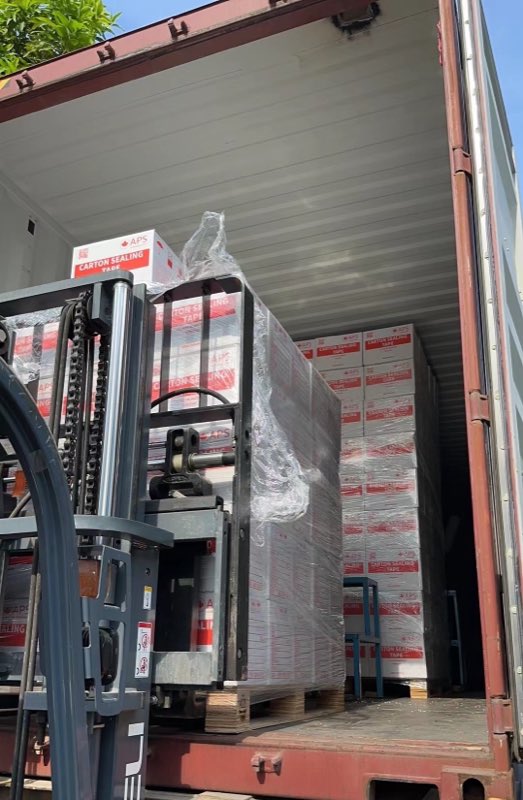 Forklift loading palletized cartons.